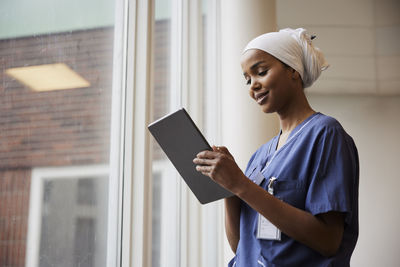 Young female doctor using tablet at work