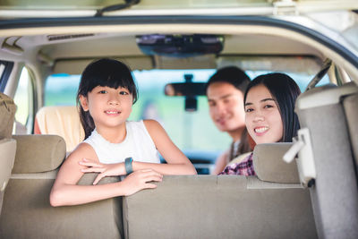 Portrait of friends sitting in car