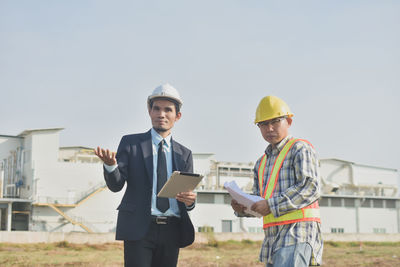 Man standing on construction site against sky