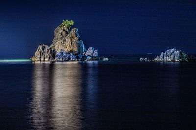 Scenic view of sea against clear blue sky at night