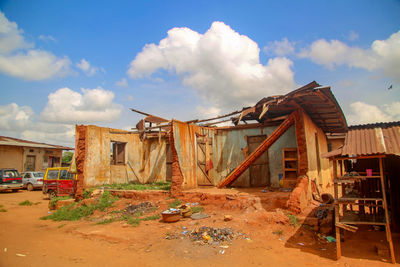Old abandoned house against sky