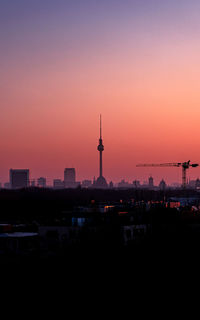 Illuminated buildings against sky during sunset