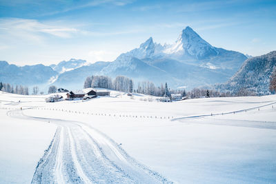 Scenic view of snow covered mountains against sky