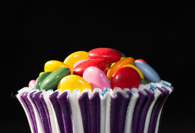 Close-up of multi colored candies against black background