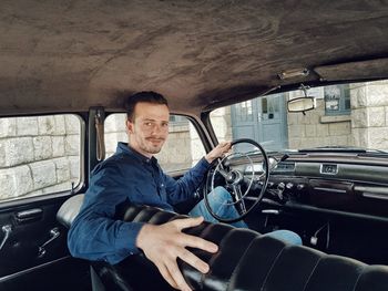 Portrait of man sitting in car