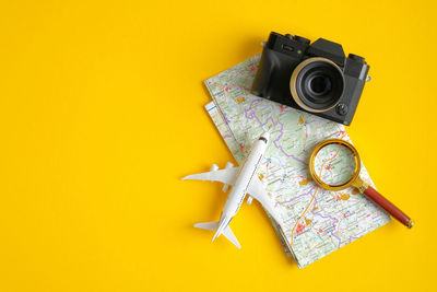 High angle view of yellow camera on table