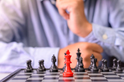 Midsection of man playing chess