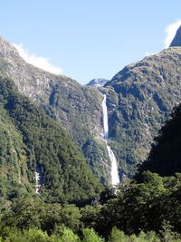 Scenic view of waterfall against sky