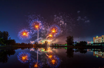 Firework display in city at night