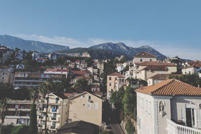 Buildings in town against sky