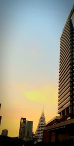 Low angle view of buildings against sky during sunset