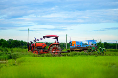 Tractor on field against sky