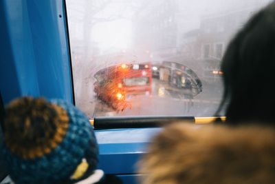 View of bus seen through land vehicle during rainy season