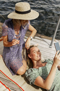 Female friends relaxing on jetty