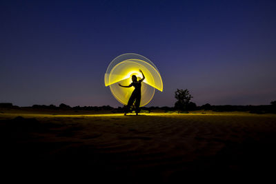 Woman with light trails at night