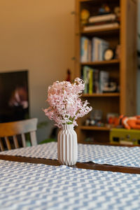 Close-up of flower vase on table at home
