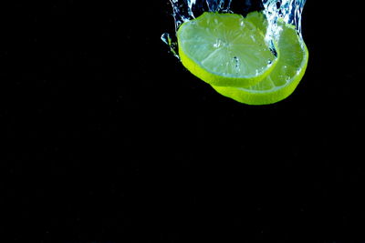 Close-up of glass of water against black background