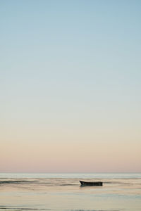 Scenic view of sea against clear sky during sunset