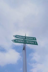 Low angle view of road sign against sky