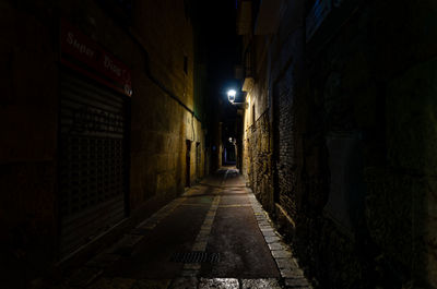 Rear view of man walking in tunnel