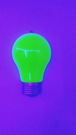 Close-up of green light against blue background