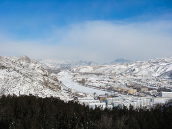 High angle view of snowcapped mountain against sky