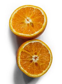 Close-up of orange slice against white background