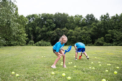 Girl with curly blonde hair plays lawn games at field day at school