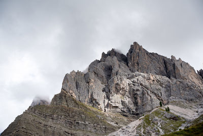 Low angle view of rocky mountains against sky