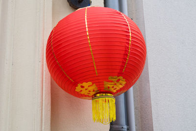 Low angle view of lantern hanging against building