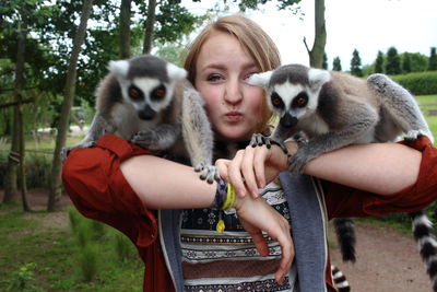 Portrait of woman with lemurs