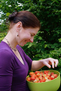 Midsection of woman holding fruit