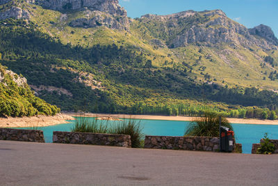 Scenic view of lake and mountains against sky