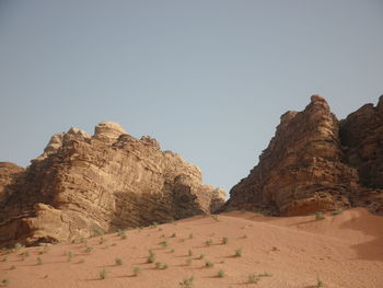 Rock formations on landscape against clear sky