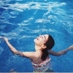 High angle view of woman swimming in pool