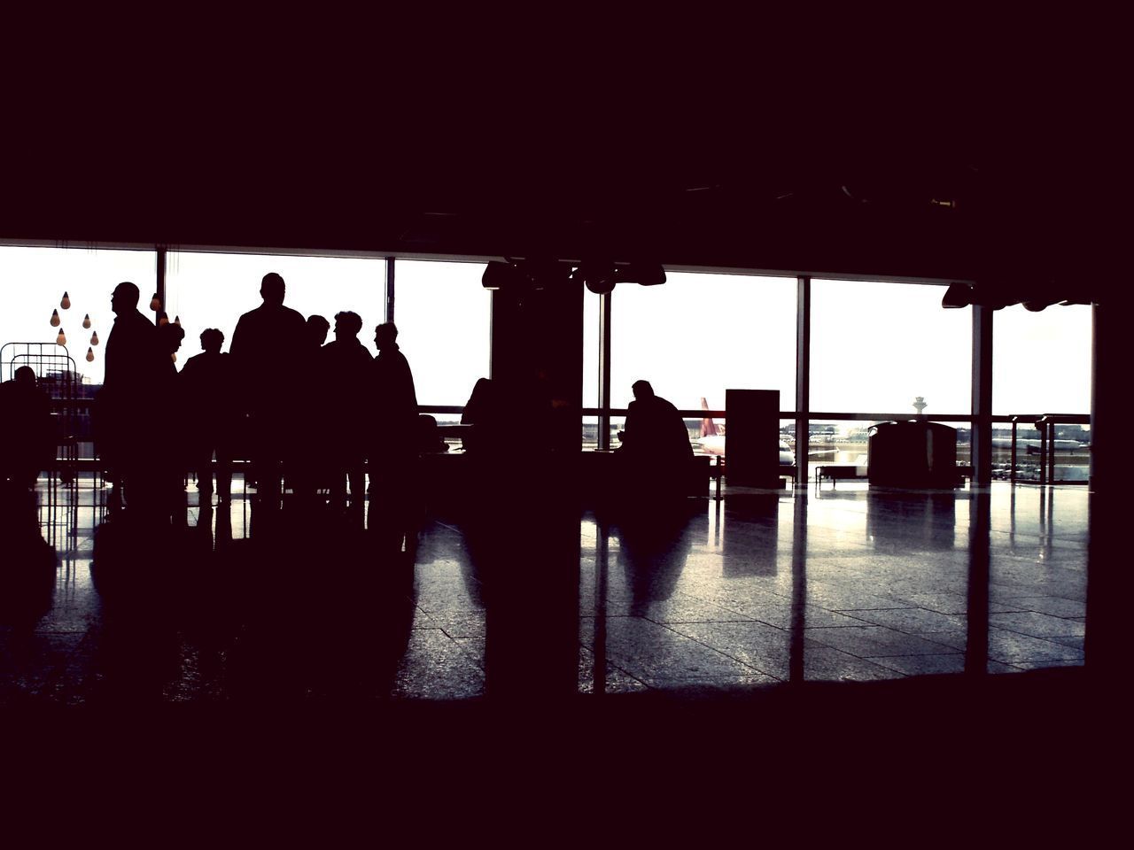 SILHOUETTE PEOPLE IN AIRPORT LOBBY