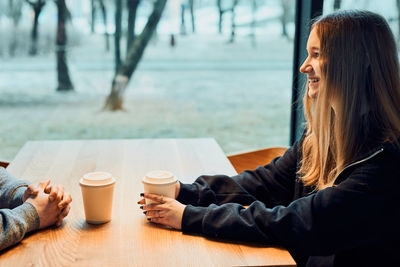 Friends having chat, talking, drinking coffee, sitting. people having break, relaxing in cafe