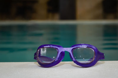 Close-up of sunglasses on swimming pool