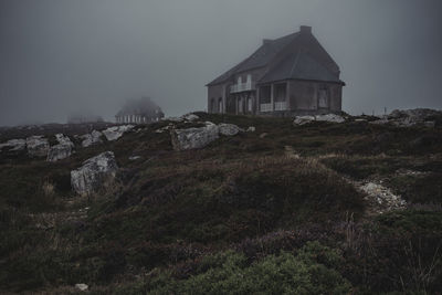 House on field against sky