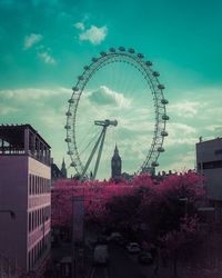 Low angle view of ferris wheel in city