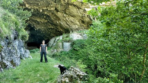 Full length of man standing against cave