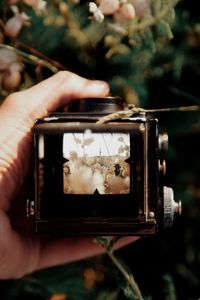 Close-up of person photographing through camera