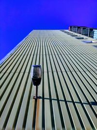 Low angle view of modern building against blue sky