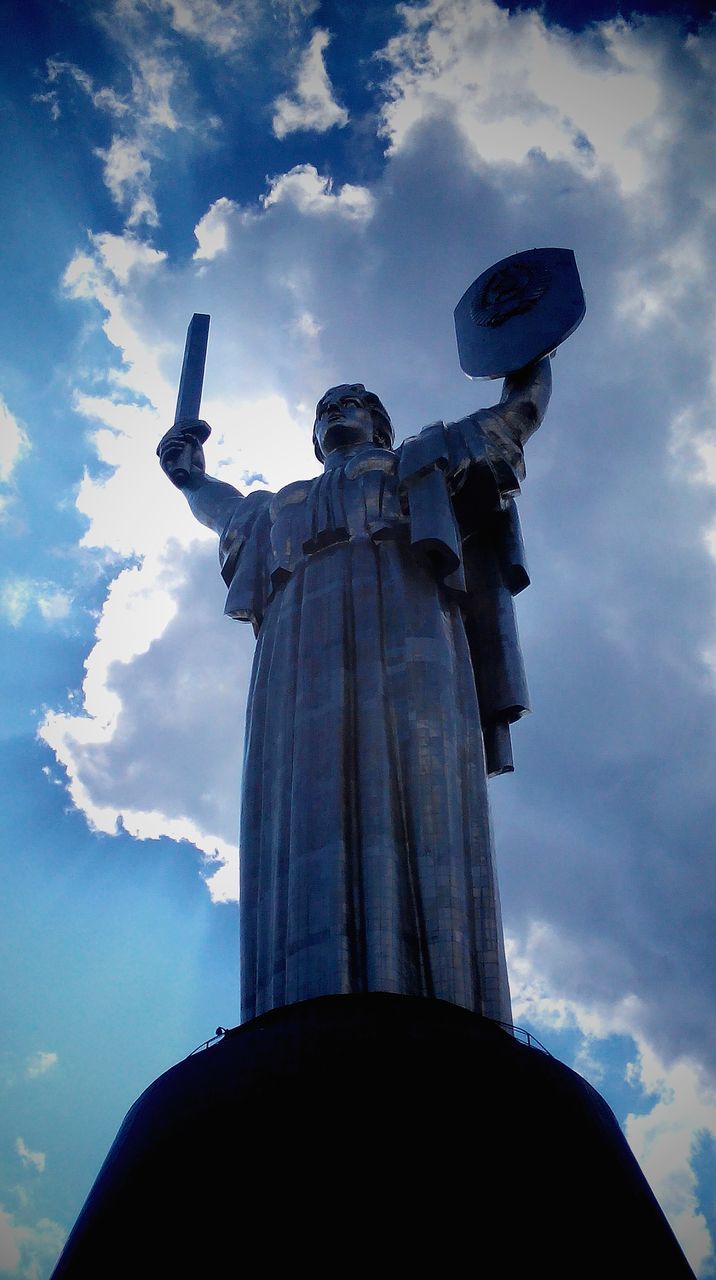 low angle view, sky, cloud - sky, built structure, architecture, religion, famous place, statue, sculpture, travel destinations, cloudy, spirituality, cloud, place of worship, travel, international landmark, tourism, human representation, building exterior