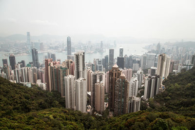 Aerial view of modern buildings in city against sky