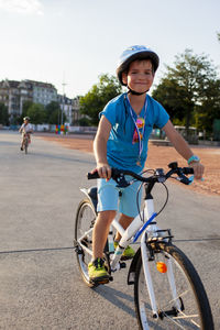 Boy riding bicycle on road