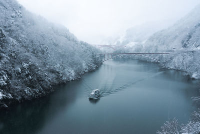 Bridge over river during winter