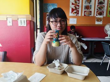 Close-up of young man sitting on table