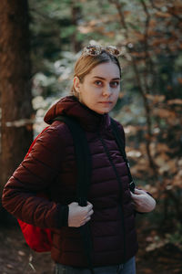 Portrait of young woman standing outdoors