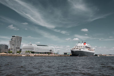 Rms queen mary 2 moored at harbor against sky